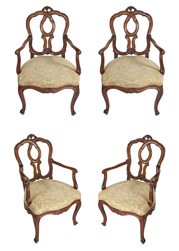 A North Italian set of four armchairs in carved walnut wood. Venice, 18th century