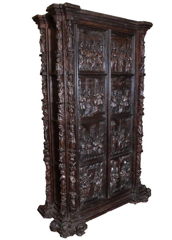A wardrobe with relief-decorated doors and carved side uprights. Late 16th, early 17th century