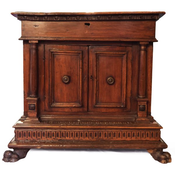 An Italian walnut wood sideboard with two doors. Hinged top opening. Tuscany, early 17th century