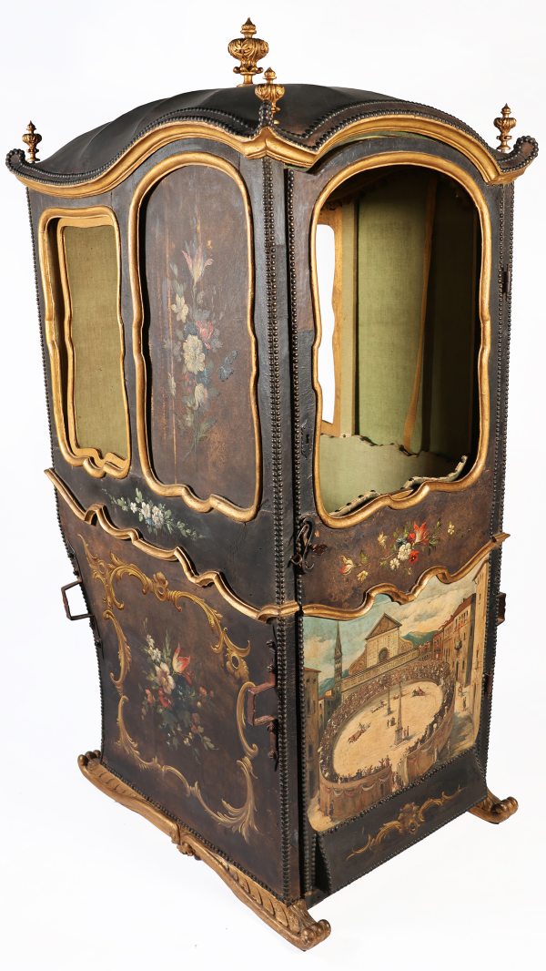 An Italian carved wood sedan chair with gilt profiles, decorations on leather. Tuscany, 18th century