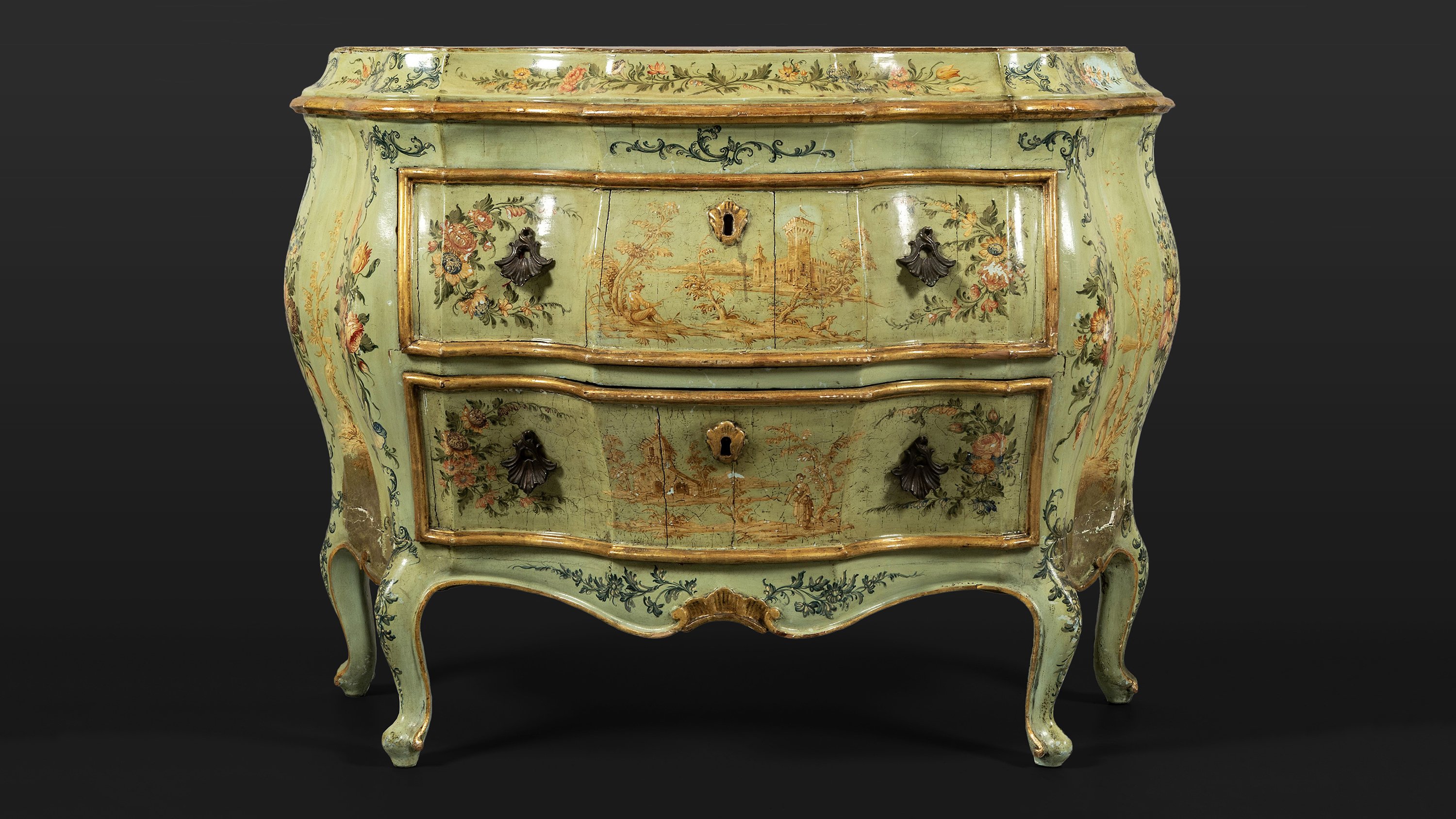 A North Italian carved wood and lacquered in polychrome with flowers and landscapes commode, Venice, mid-18th century